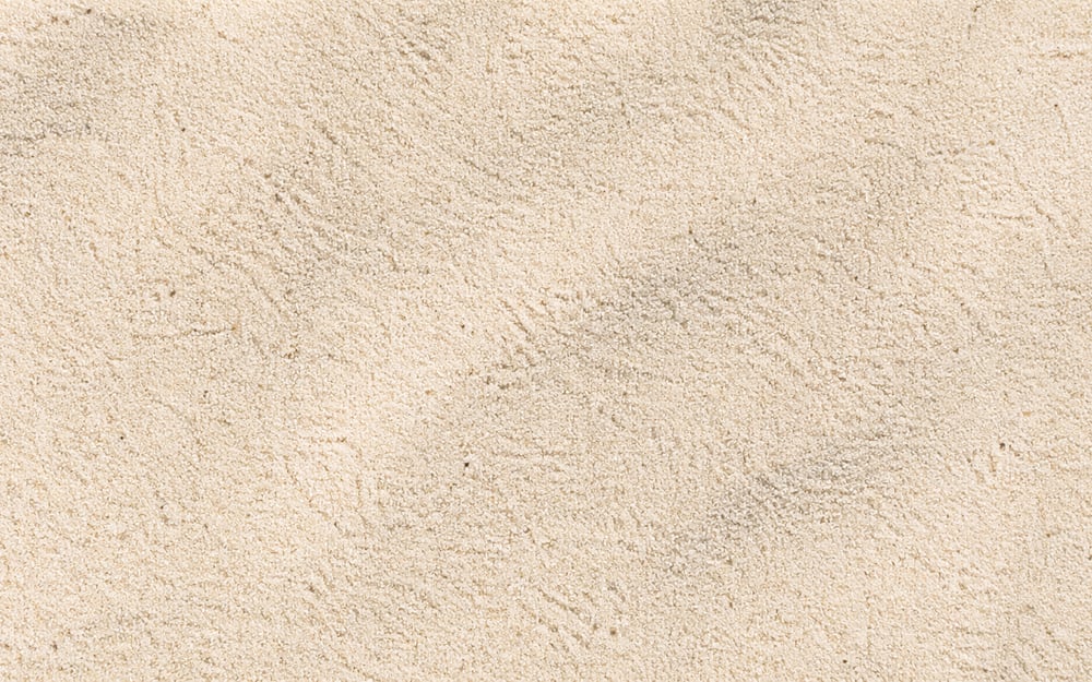 Close-up da textura de areia fina, grão uniforme e claro